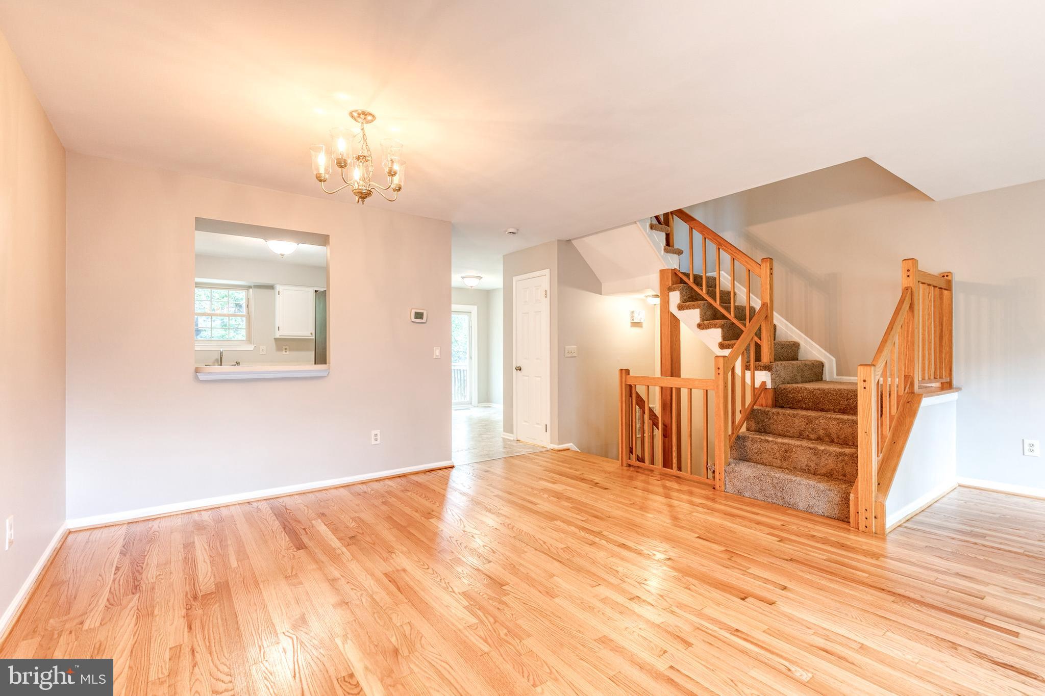 7327 Eden Brook Drive, Unit E30 Columbia, MD 21046 - Photo 16 of 40 a view of empty room with wooden floor and fan