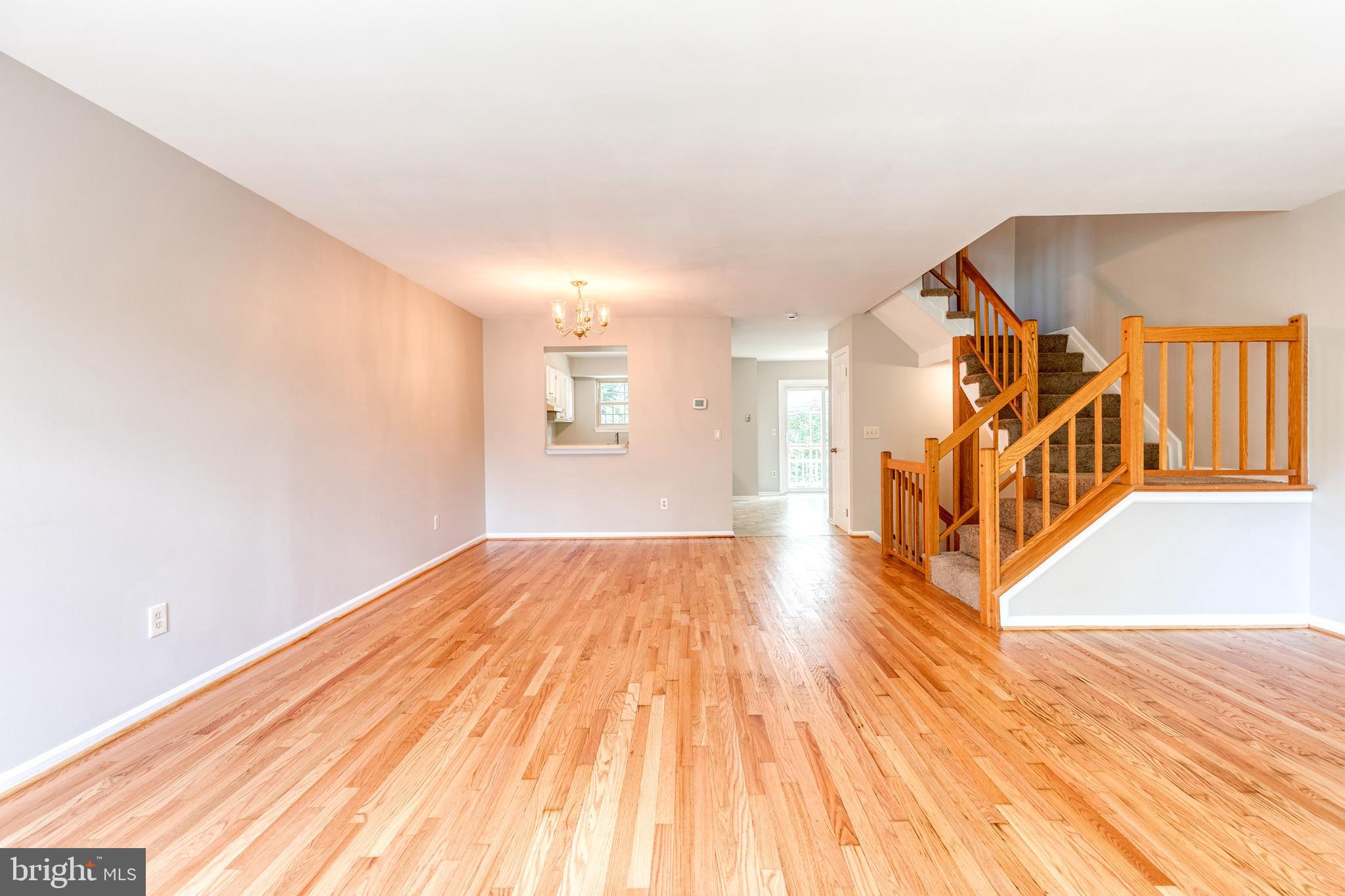 7327 Eden Brook Drive, Unit E30 Columbia, MD 21046 - Photo 17 of 40 a view of an empty room with wooden floor and a window