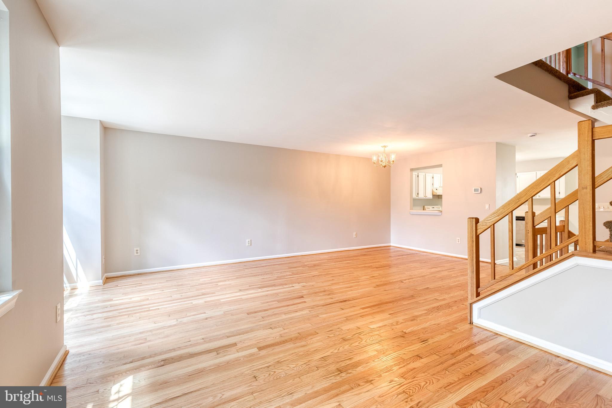 7327 Eden Brook Drive, Unit E30 Columbia, MD 21046 - Photo 18 of 40 a view of an empty room with wooden floor and a window