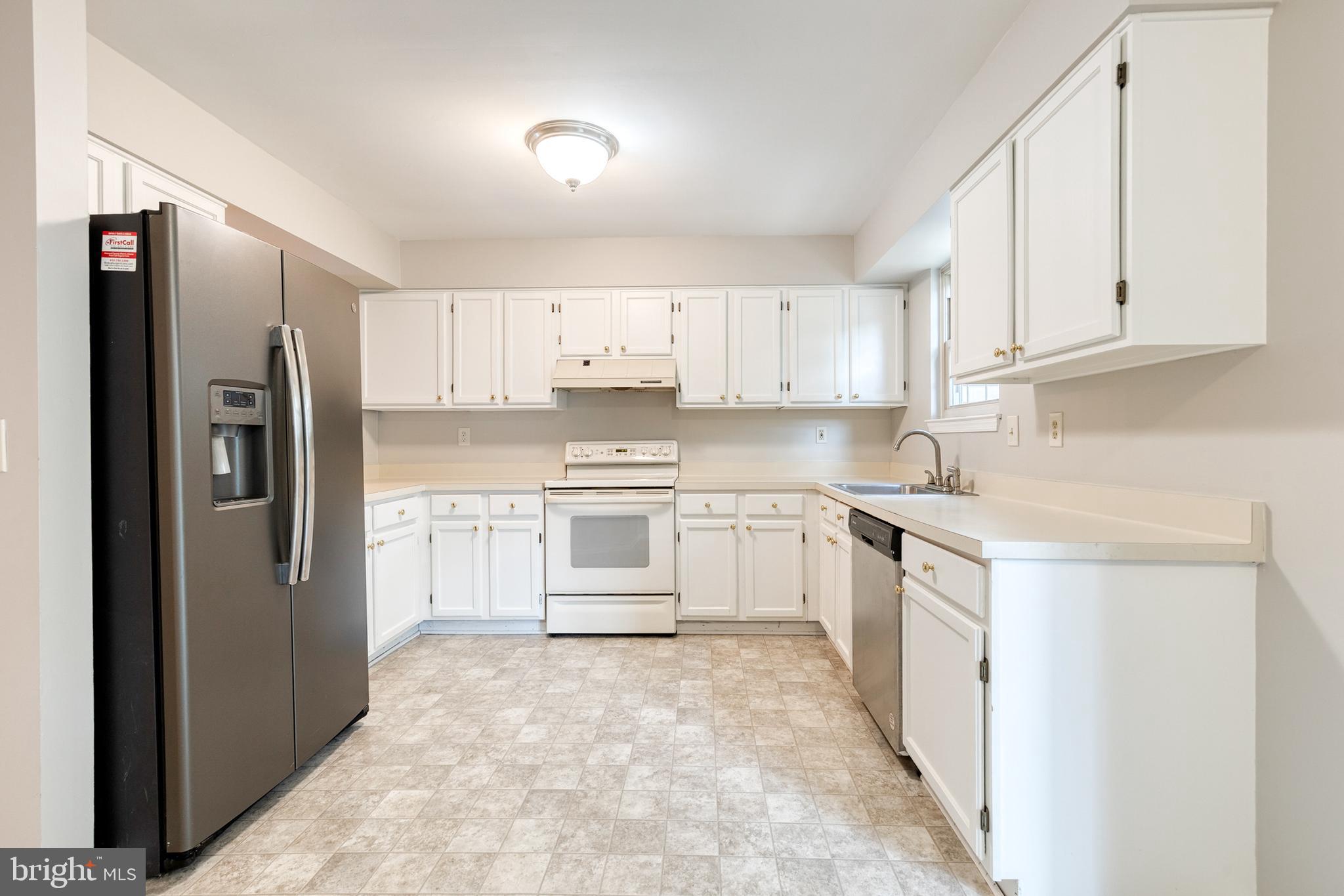 7327 Eden Brook Drive, Unit E30 Columbia, MD 21046 - Photo 20 of 40 a kitchen with white cabinets and stainless steel appliances