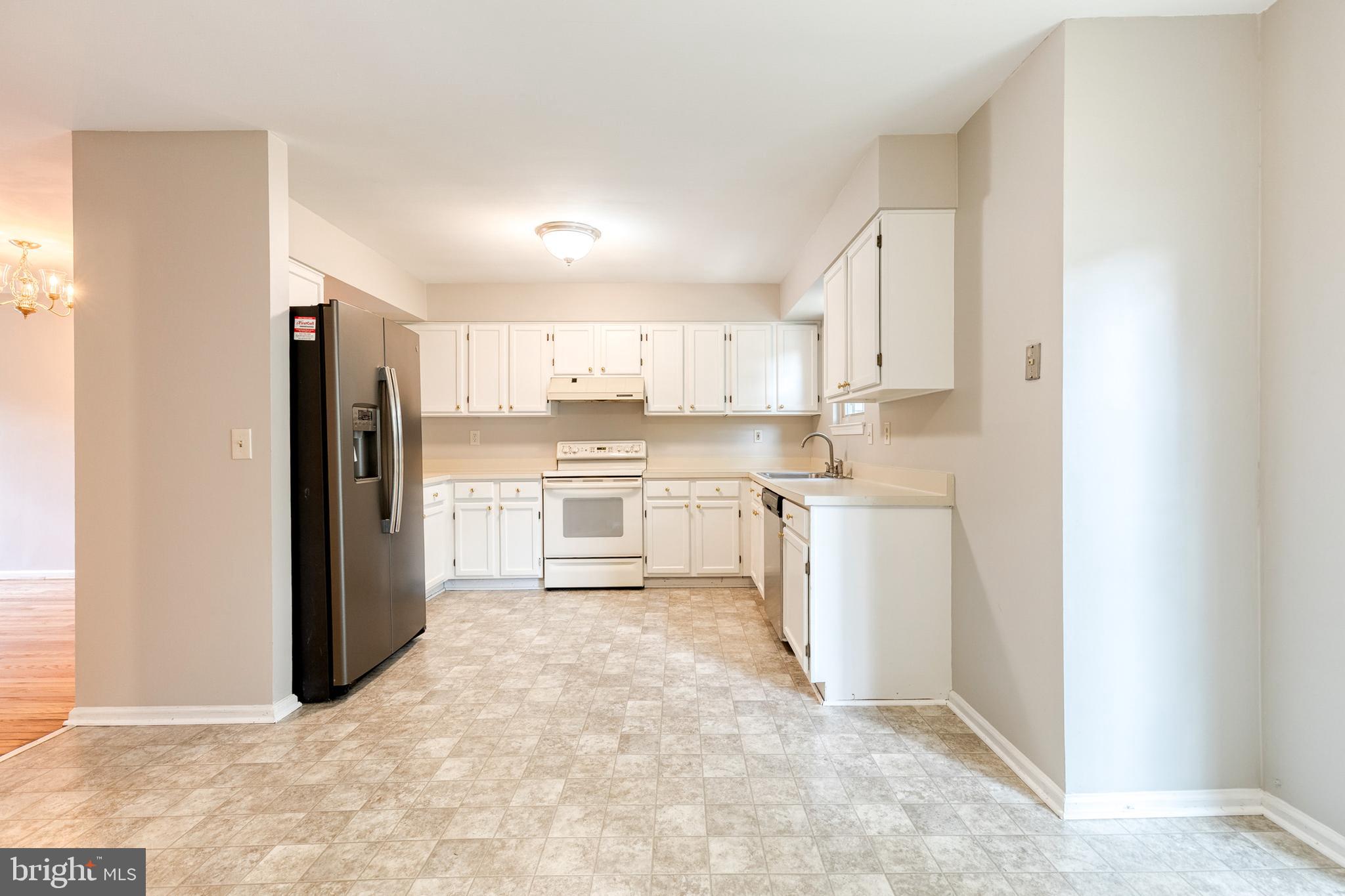 7327 Eden Brook Drive, Unit E30 Columbia, MD 21046 - Photo 21 of 40 a kitchen with white cabinets and stainless steel appliances