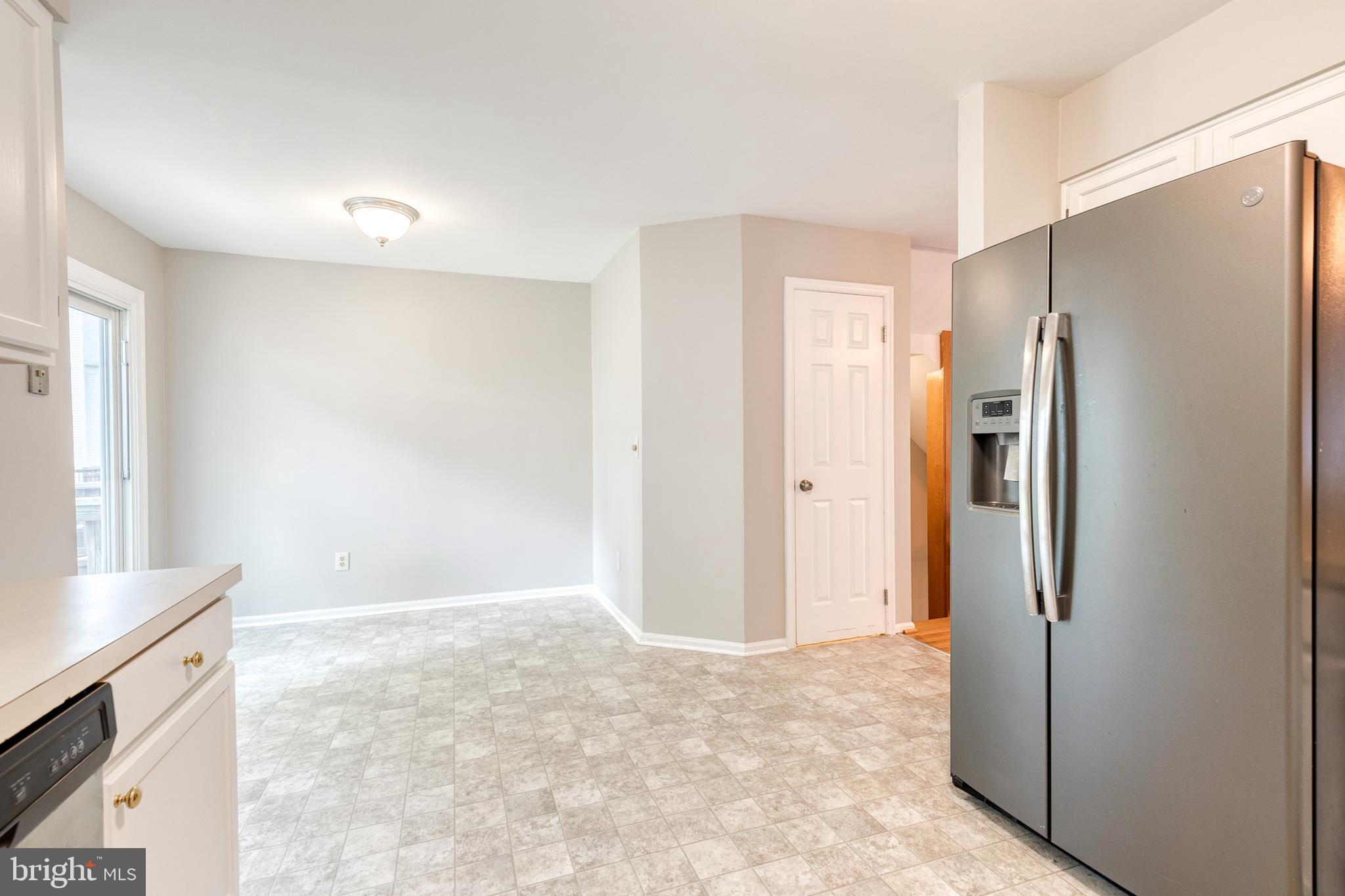 7327 Eden Brook Drive, Unit E30 Columbia, MD 21046 - Photo 23 of 40 a view of a kitchen with a refrigerator cabinets and a wooden floor