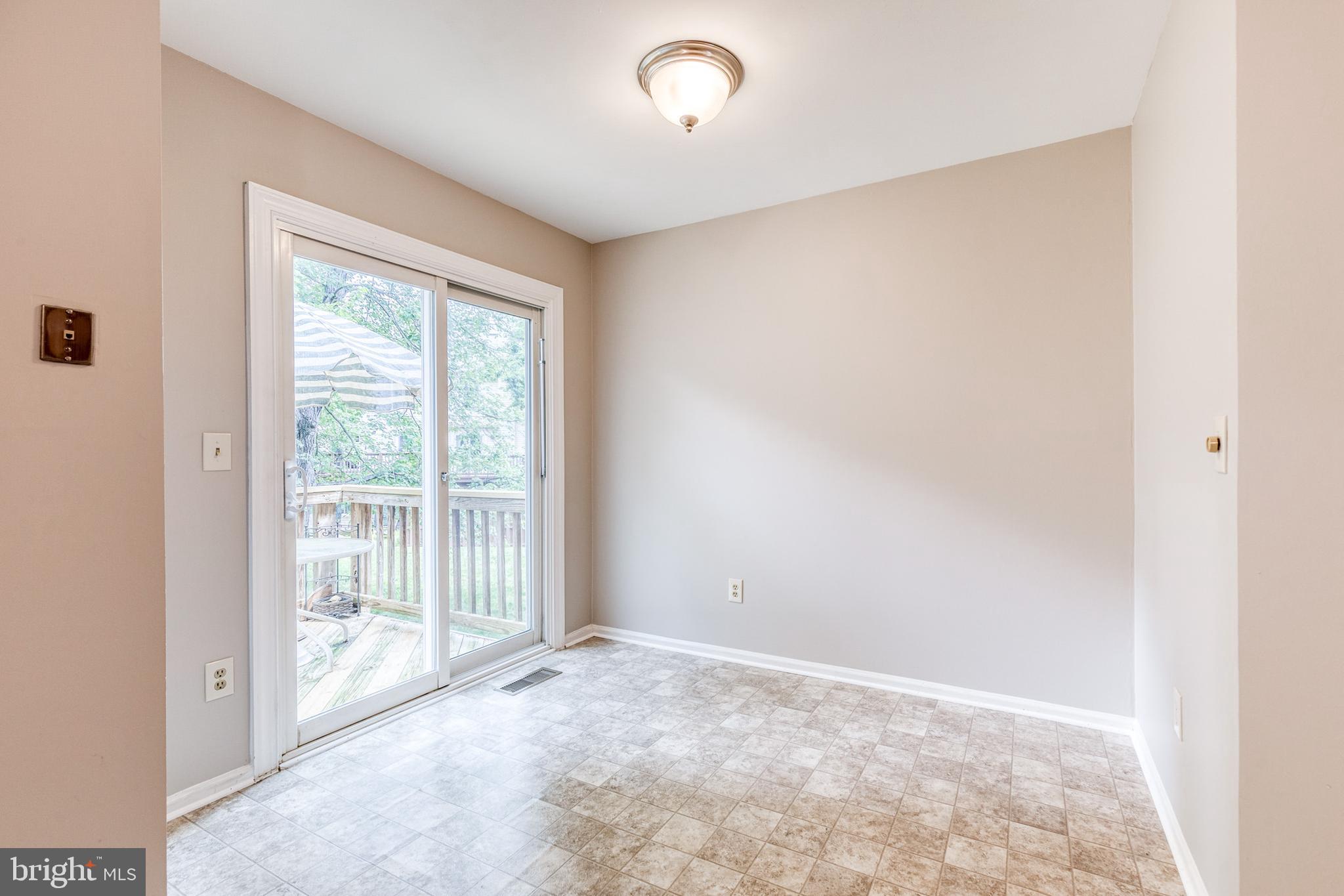 7327 Eden Brook Drive, Unit E30 Columbia, MD 21046 - Photo 24 of 40 an empty room with wooden floor and windows