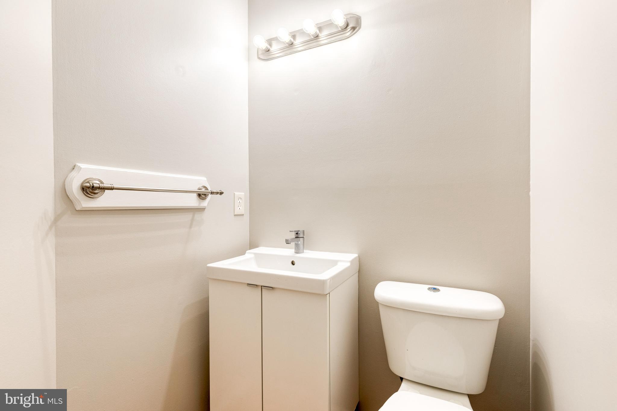 7327 Eden Brook Drive, Unit E30 Columbia, MD 21046 - Photo 26 of 40 a bathroom with a toilet sink and mirror