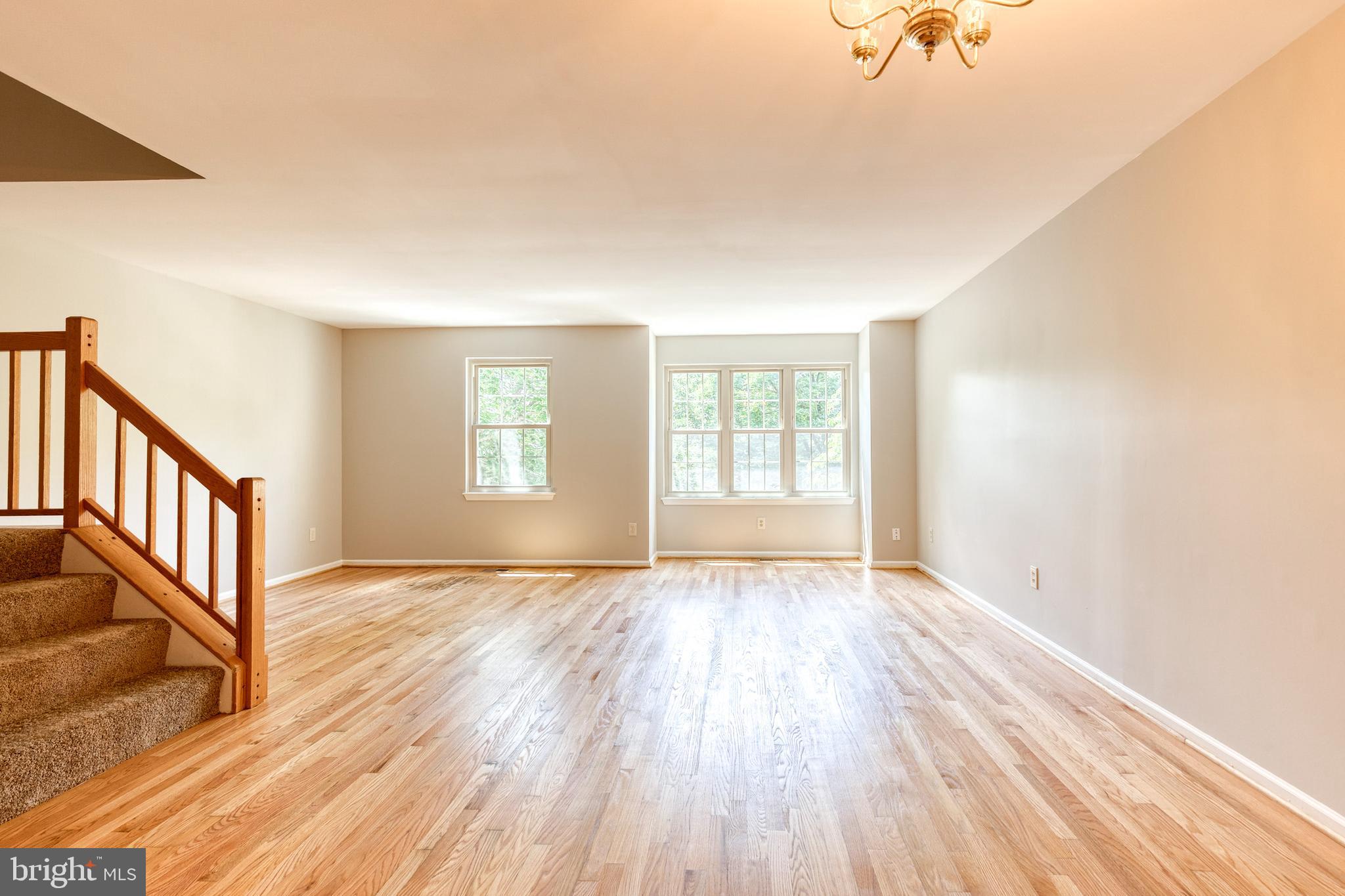7327 Eden Brook Drive, Unit E30 Columbia, MD 21046 - Photo 3 of 40 an empty room with wooden floor and windows