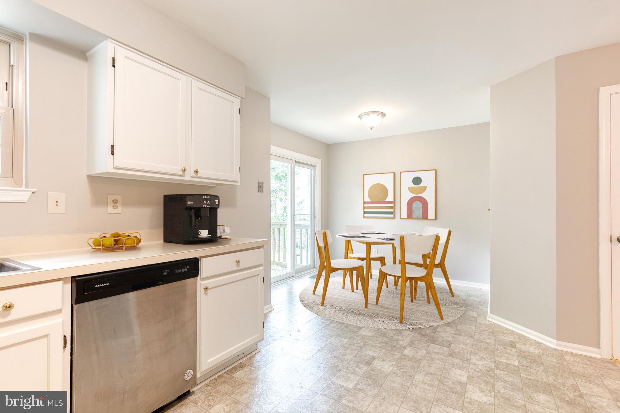 7327 Eden Brook Drive, Unit E30 Columbia, MD 21046 - Photo 8 of 40 a kitchen with stainless steel appliances granite countertop a table chairs and a refrigerator