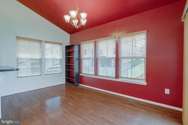 a view of a kitchen with a sink and wooden floor