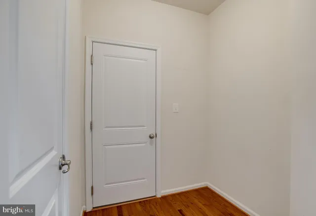 a view of an empty room and chandelier fan
