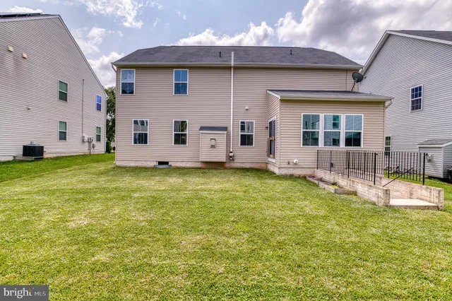 an aerial view of a house with swimming pool garden and patio