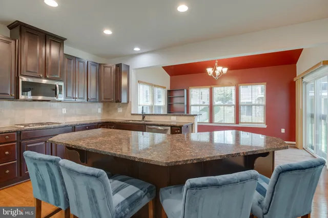 a kitchen with a table and chairs in it