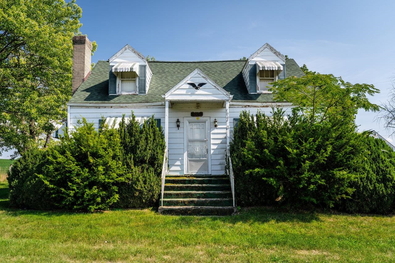 a front view of a house with a garden