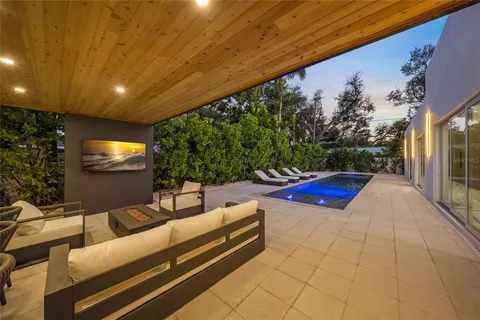 a view of a patio with table and chairs potted plants with wooden floor