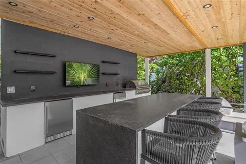 a view of a balcony with wooden floor and outdoor seating