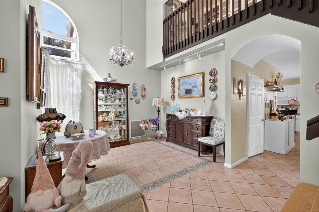 2119 Chagall Circle West Palm Beach, FL 33409 - Photo 11 of 63 a living room with furniture a chandelier and a flat screen tv