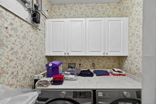 a living room with lots of furniture and clutter