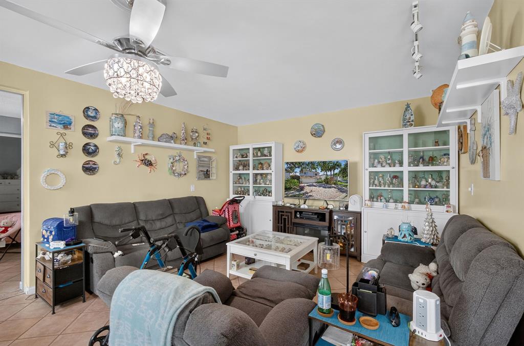 2119 Chagall Circle West Palm Beach, FL 33409 - Photo 22 of 63 a living room with furniture chandelier and a large window