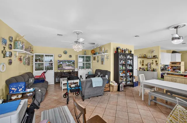 a living room filled with furniture and a chandelier