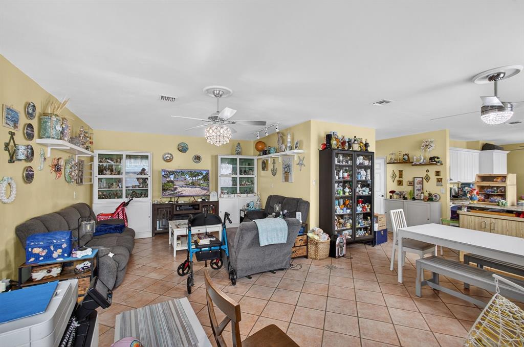 2119 Chagall Circle West Palm Beach, FL 33409 - Photo 23 of 63 a living room with furniture and a chandelier