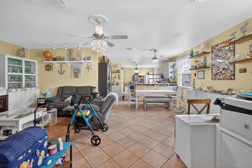 2119 Chagall Circle West Palm Beach, FL 33409 - Photo 28 of 63 a living room filled with furniture and a chandelier