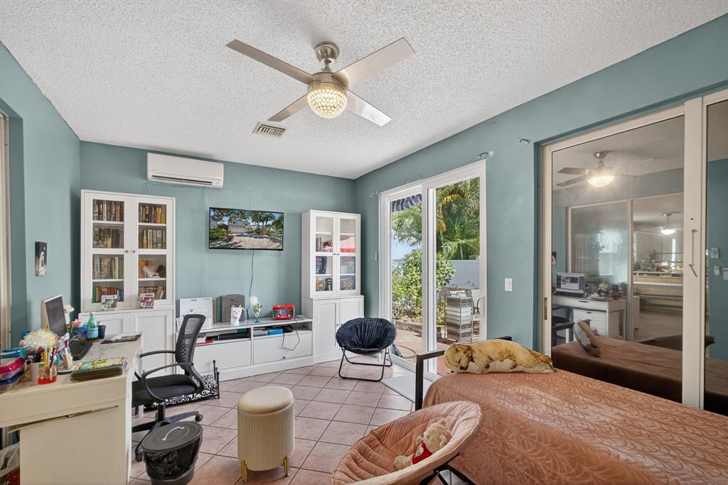 2119 Chagall Circle West Palm Beach, FL 33409 - Photo 30 of 63 a room with furniture a large window and gym equipment