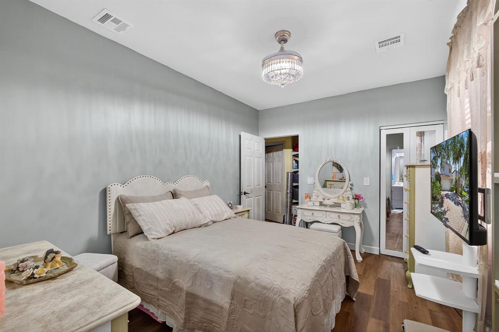 2119 Chagall Circle West Palm Beach, FL 33409 - Photo 32 of 63 a bedroom with a bed and a flat screen tv