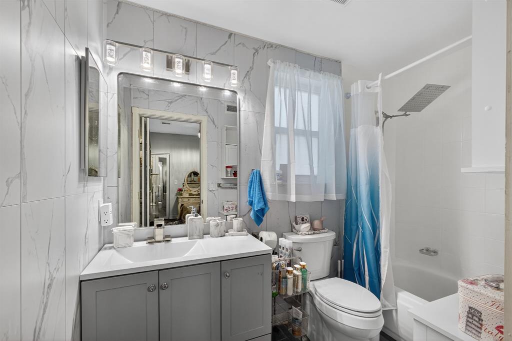 2119 Chagall Circle West Palm Beach, FL 33409 - Photo 33 of 63 a bathroom with a sink toilet mirror and shower