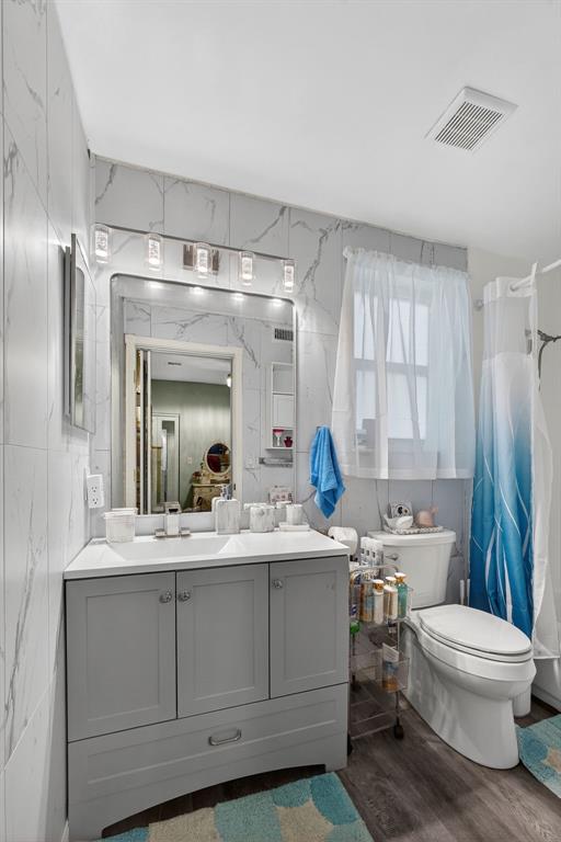 2119 Chagall Circle West Palm Beach, FL 33409 - Photo 35 of 63 a bathroom with a double vanity sink toilet and shower