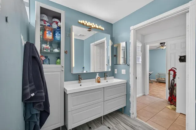 a patio with a table and chairs under an umbrella
