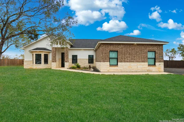 a front view of a house with a yard