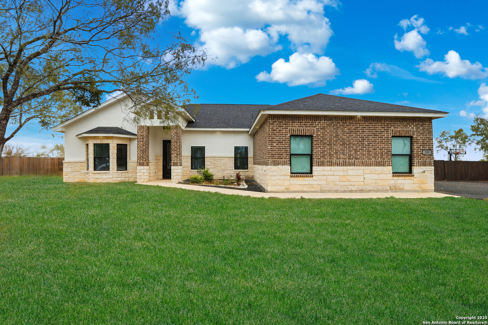 128 Hidden Ranch Court Floresville, TX 78114 - Photo 1 of 38 a front view of a house with a yard