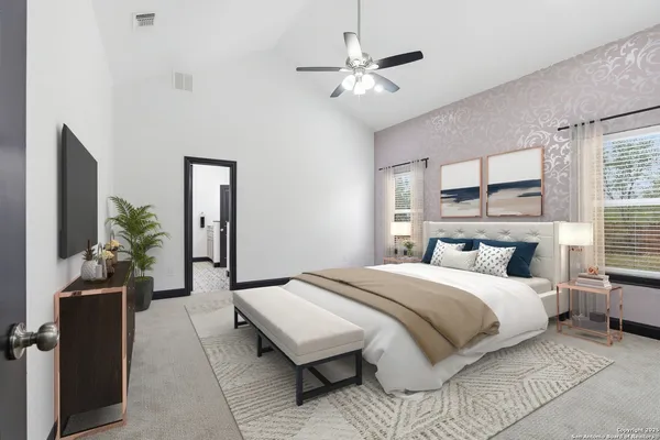a bedroom with a large bed and a chandelier