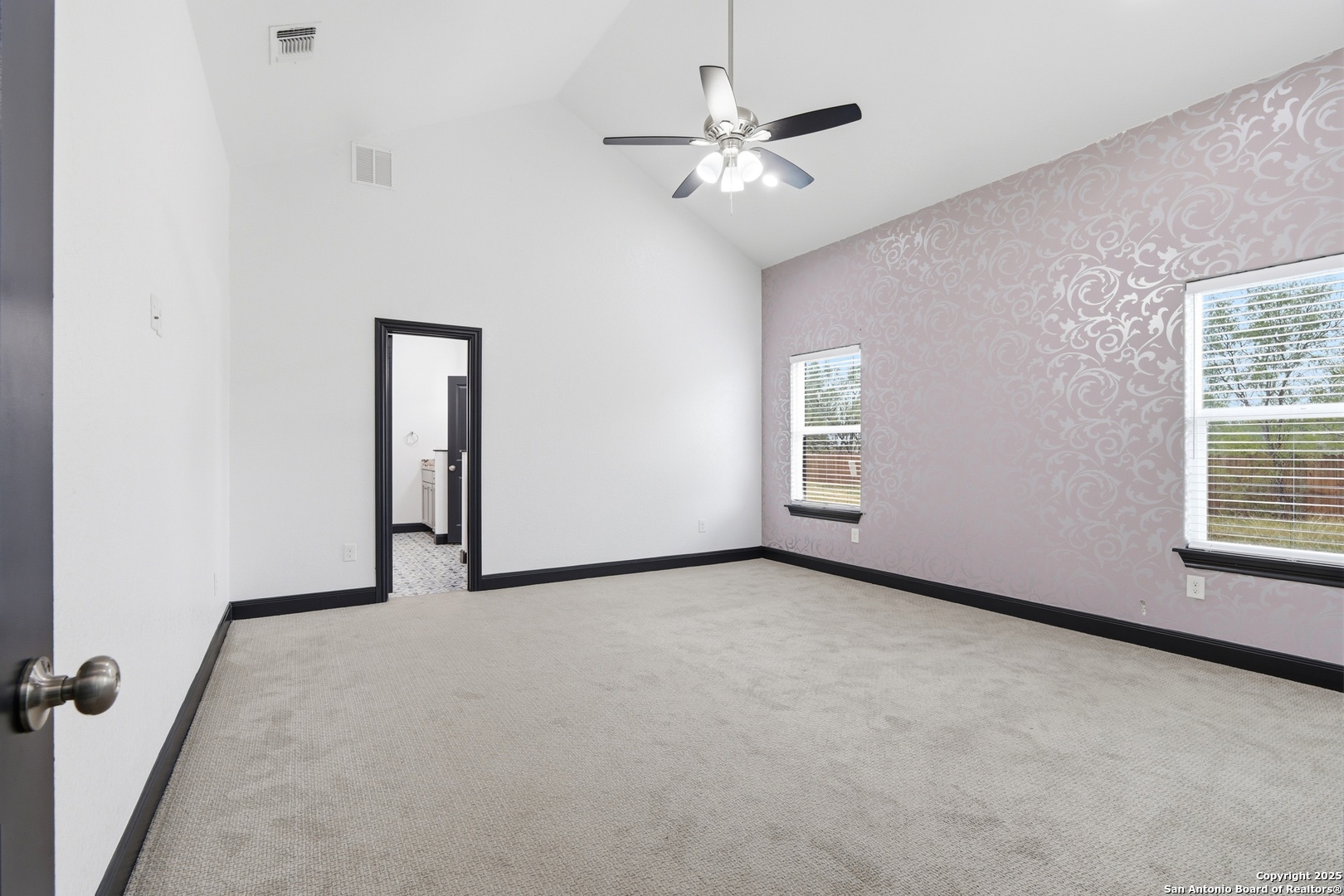 128 Hidden Ranch Court Floresville, TX 78114 - Photo 20 of 38 an empty room with chandelier fan and windows