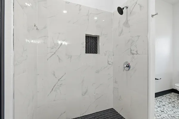 a bathroom with a shower and a sink