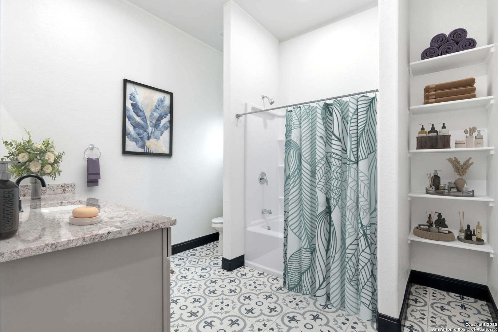 128 Hidden Ranch Court Floresville, TX 78114 - Photo 26 of 38 a bathroom with a sink a toilet and shower curtain