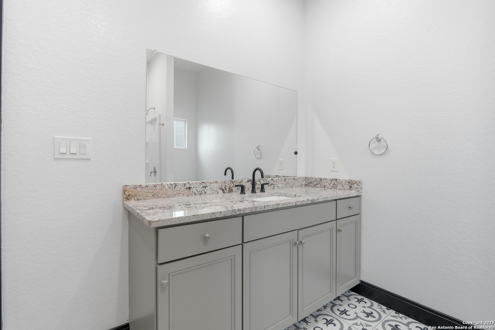 128 Hidden Ranch Court Floresville, TX 78114 - Photo 27 of 38 a bathroom with a granite countertop sink and a mirror