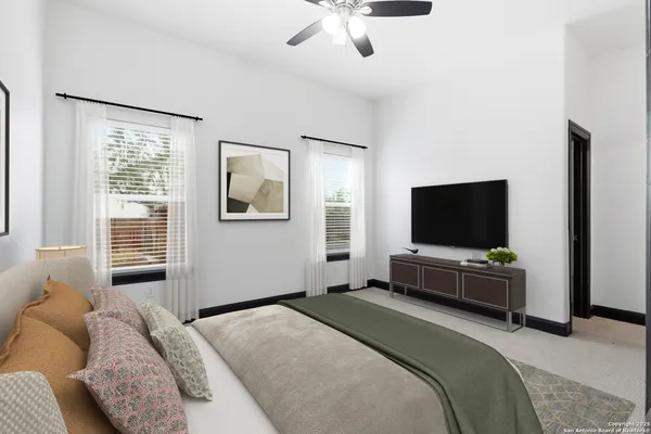 a bedroom with a bed and a flat screen tv on the dresser