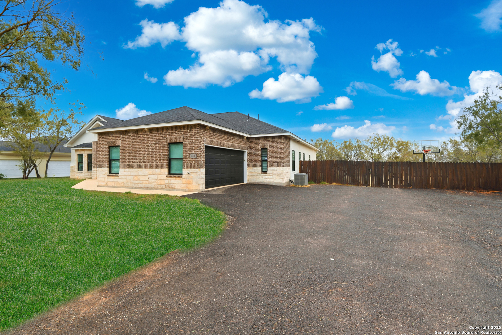 128 Hidden Ranch Court Floresville, TX 78114 - Photo 3 of 38 a view of a white house with a yard