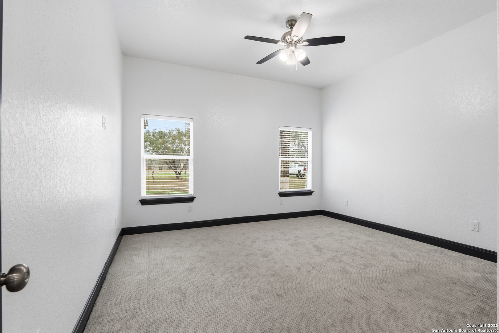 128 Hidden Ranch Court Floresville, TX 78114 - Photo 33 of 38 an empty room with windows and fan