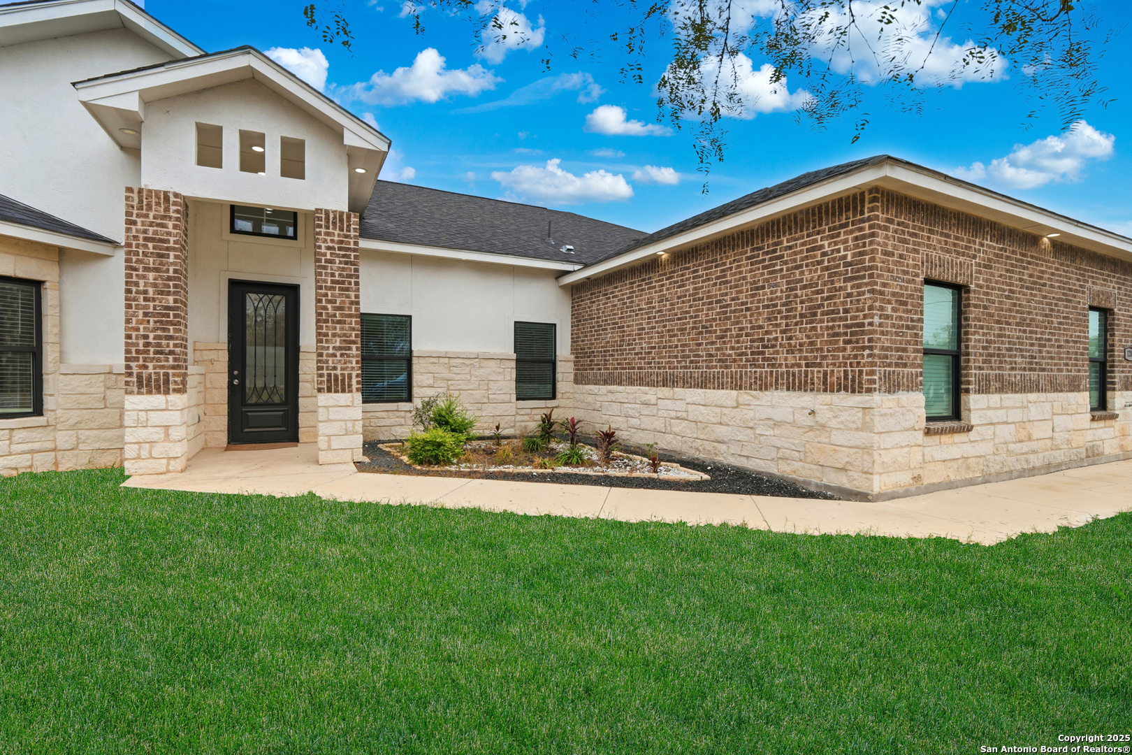 128 Hidden Ranch Court Floresville, TX 78114 - Photo 5 of 38 a front view of a house with a yard and garage