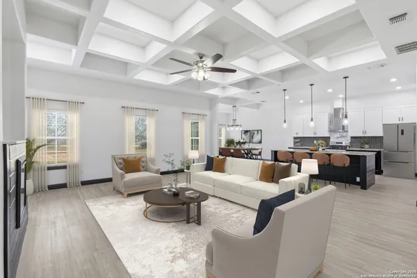 a living room with furniture kitchen view and a large window