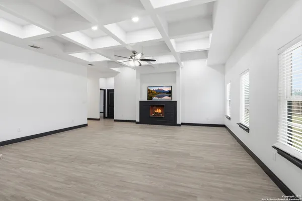 an empty room with wooden floor and window