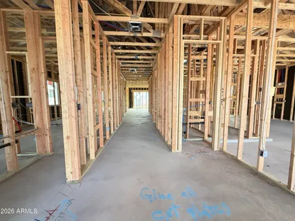a view of a hallway with wooden floor and door