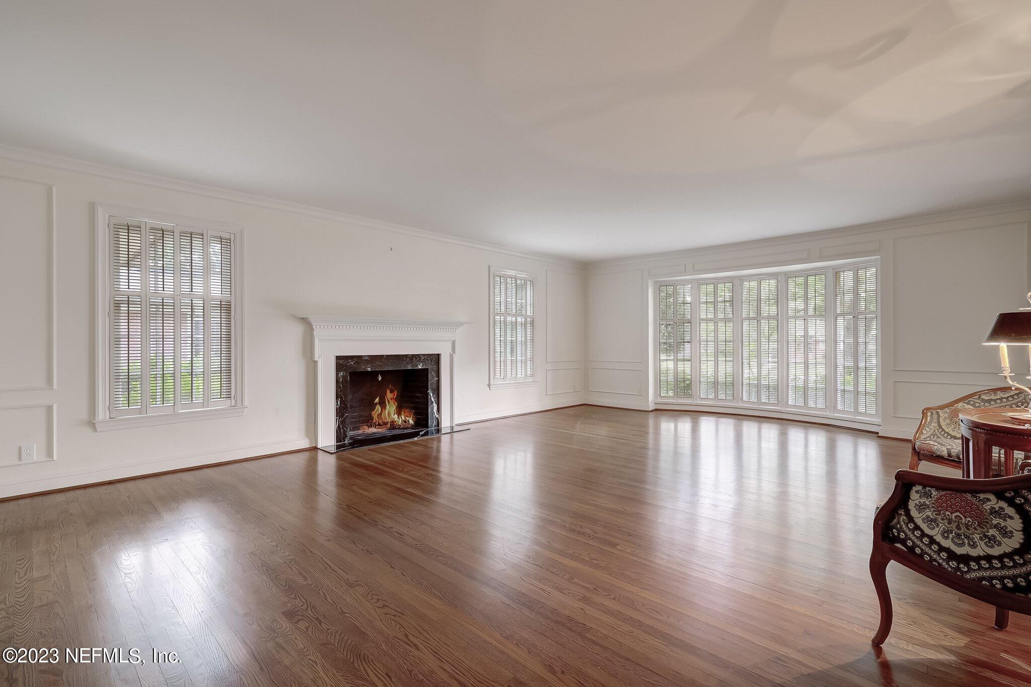 4143 Sherwood Road Jacksonville, FL 32210 - Photo 11 of 67 a view of an empty room with window and wooden floor