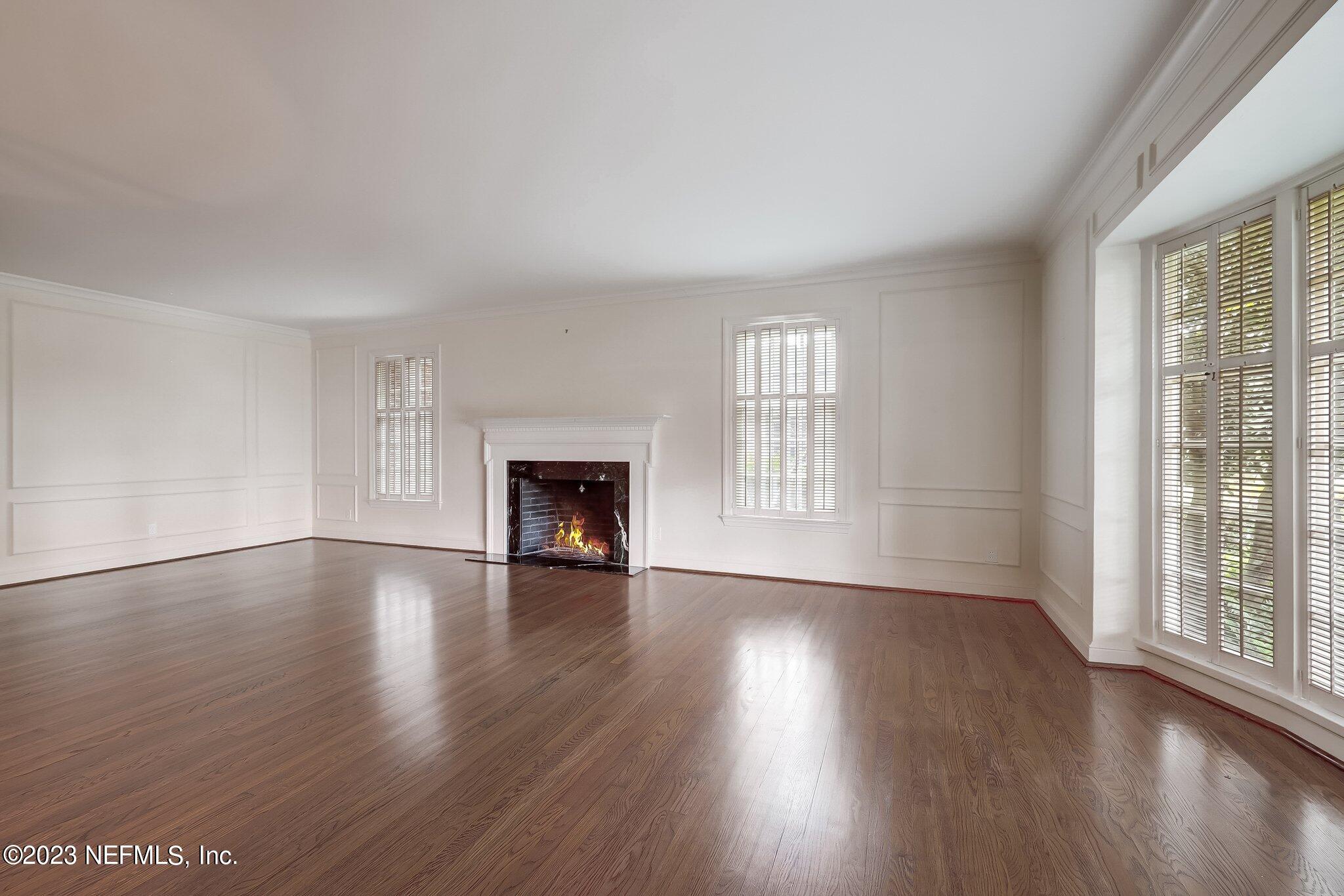 4143 Sherwood Road Jacksonville, FL 32210 - Photo 13 of 67 an empty room with wooden floor and windows