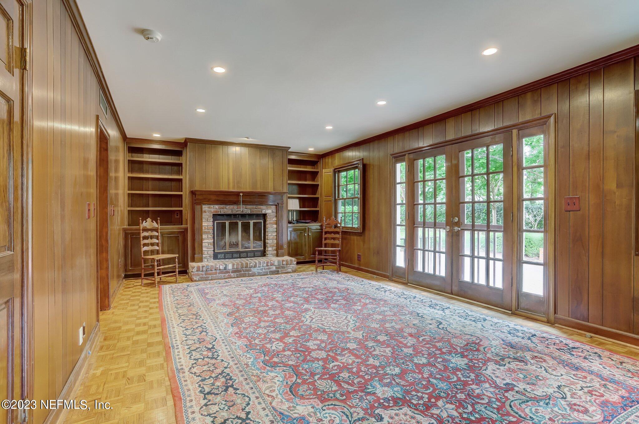 4143 Sherwood Road Jacksonville, FL 32210 - Photo 14 of 67 a view of an empty room with a fireplace and a window