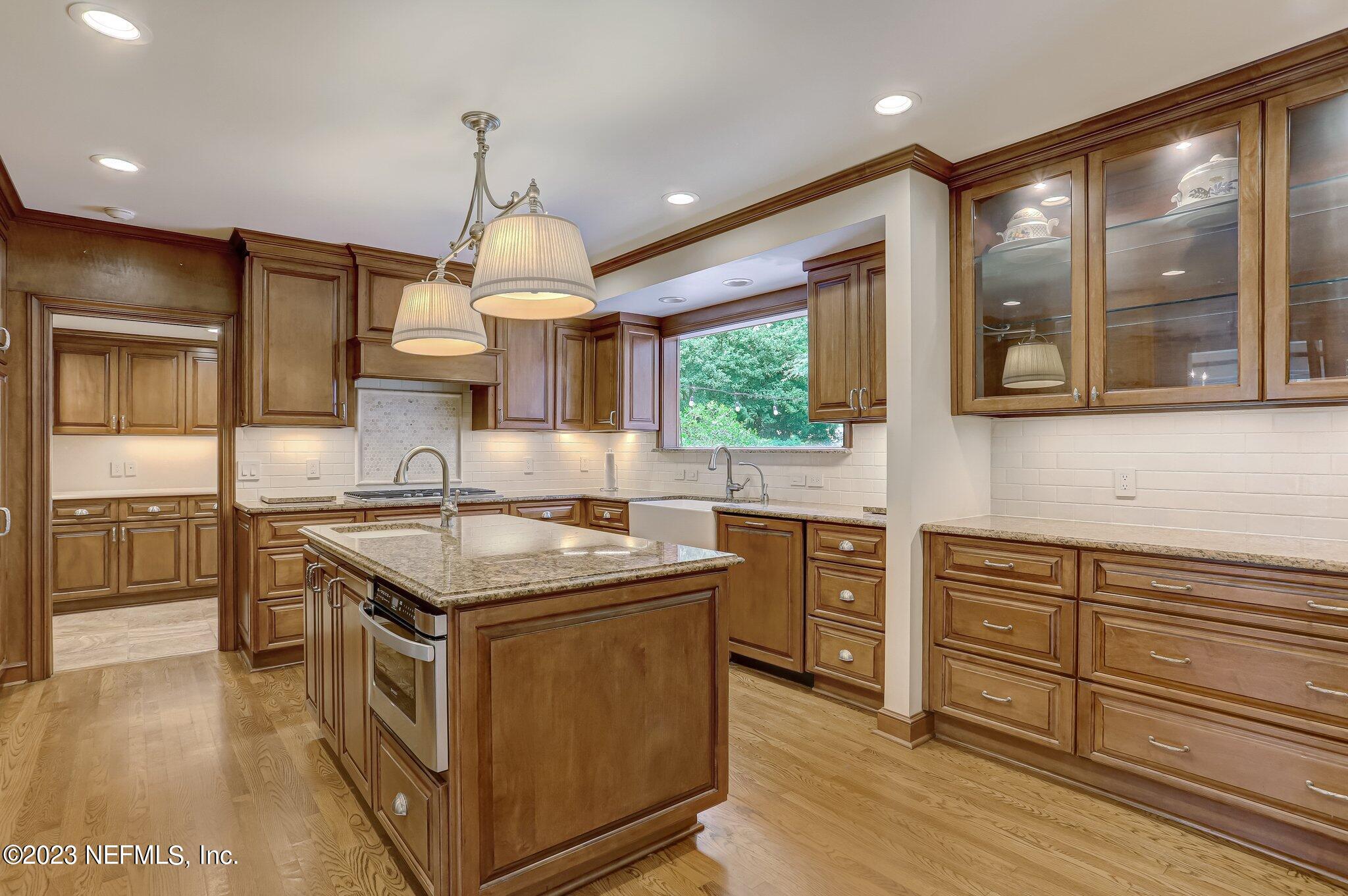 4143 Sherwood Road Jacksonville, FL 32210 - Photo 21 of 67 a kitchen with a stove a sink and a wooden floors