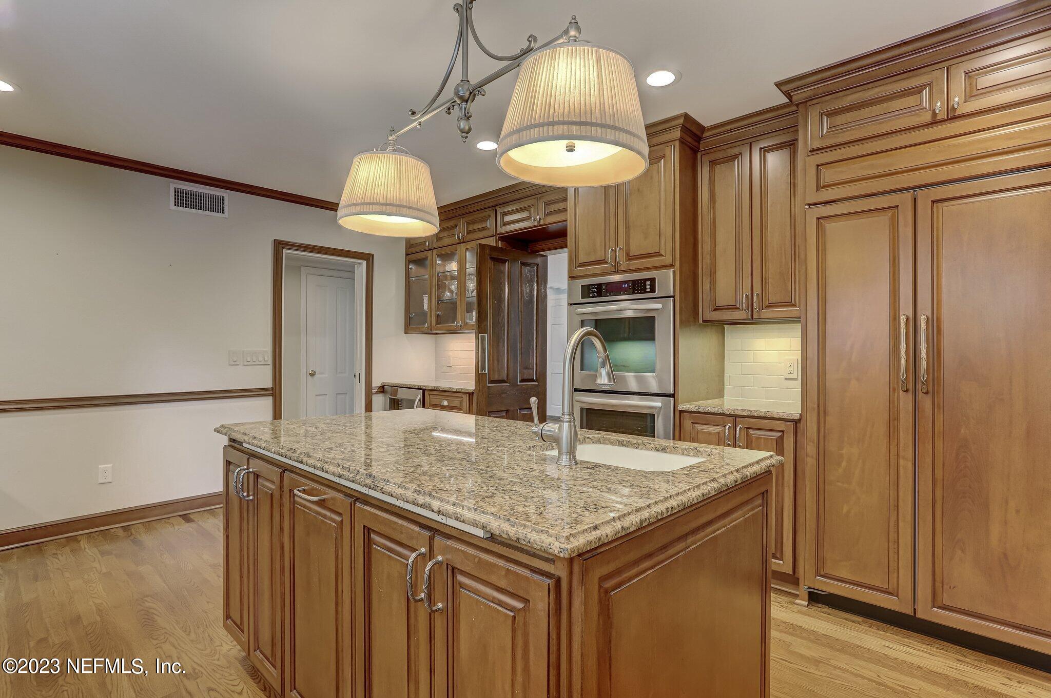 4143 Sherwood Road Jacksonville, FL 32210 - Photo 23 of 67 a kitchen with stainless steel appliances granite countertop a sink and a refrigerator