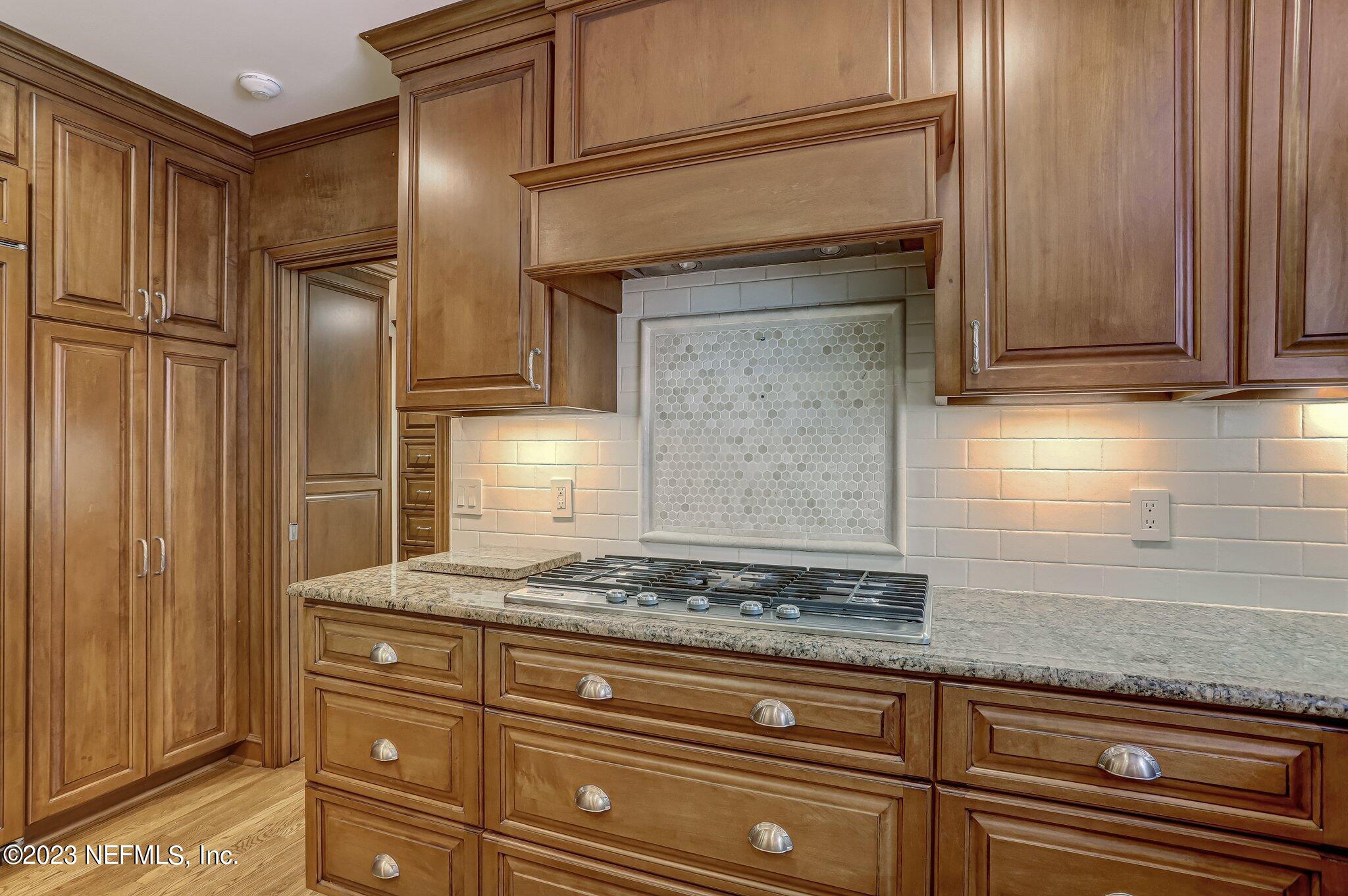 4143 Sherwood Road Jacksonville, FL 32210 - Photo 26 of 67 a kitchen with granite countertop cabinets stainless steel appliances and a counter top space