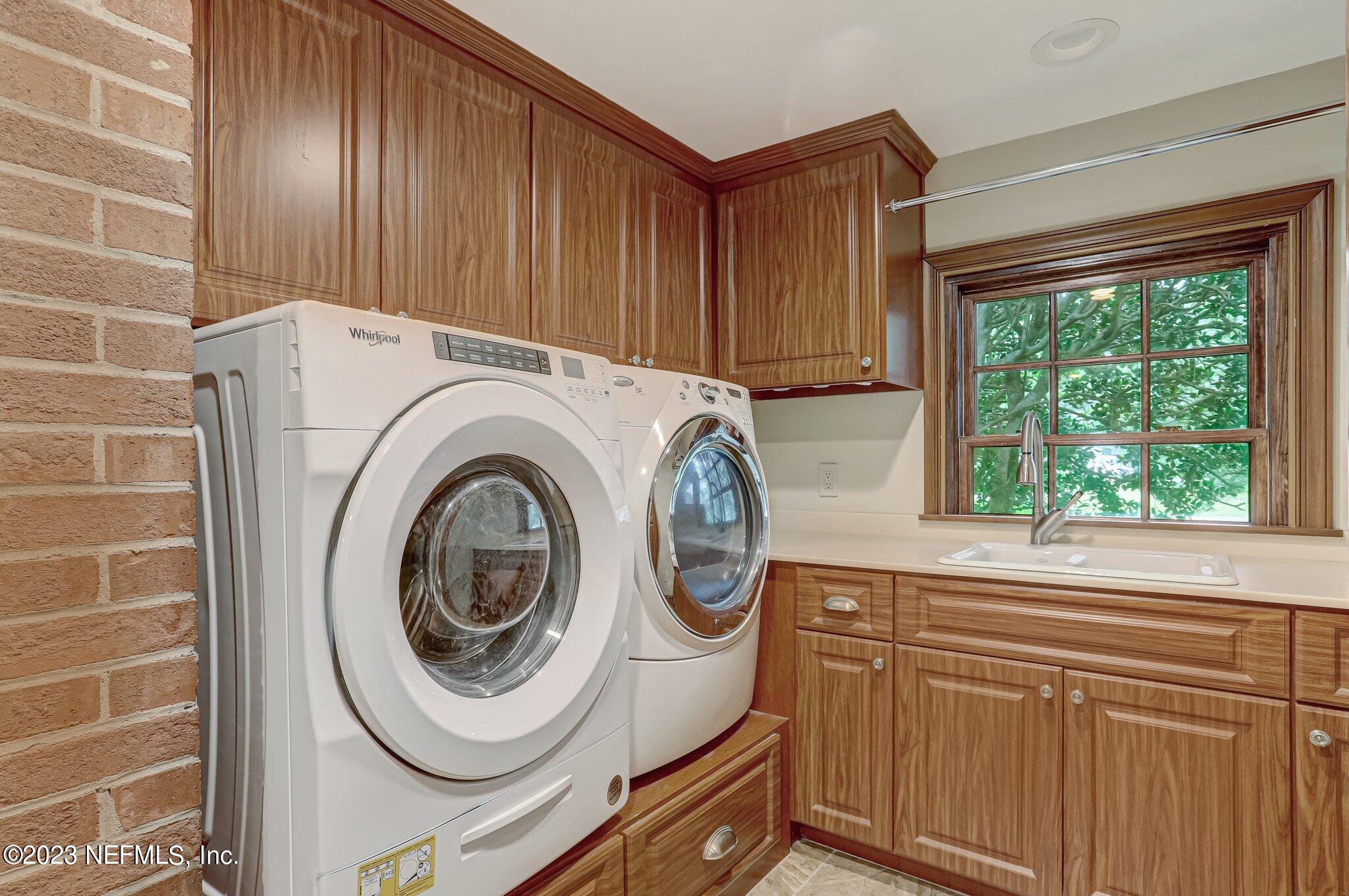 4143 Sherwood Road Jacksonville, FL 32210 - Photo 31 of 67 a utility room with dryer and washer