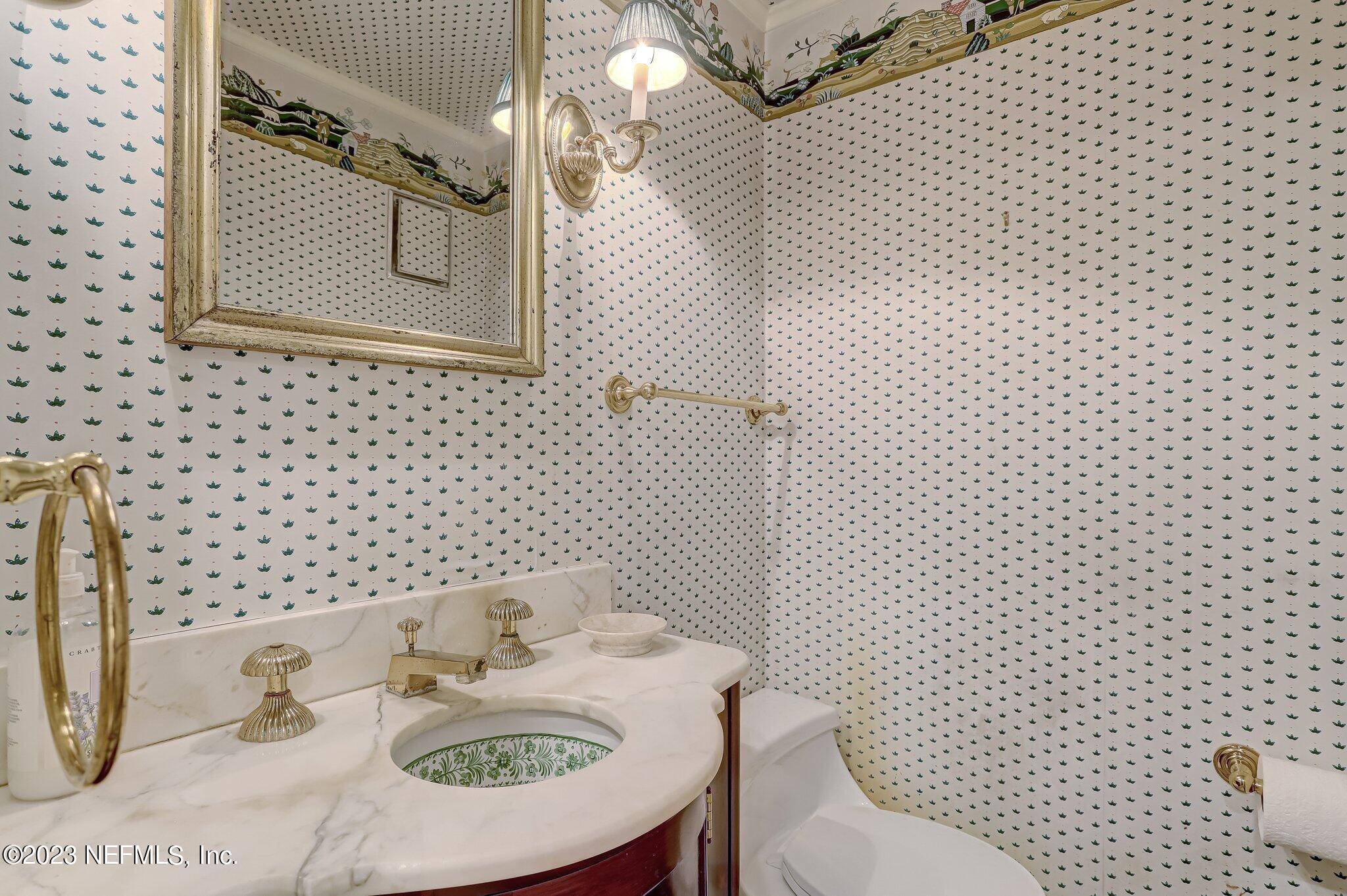 4143 Sherwood Road Jacksonville, FL 32210 - Photo 35 of 67 a bathroom with a sink and a mirror